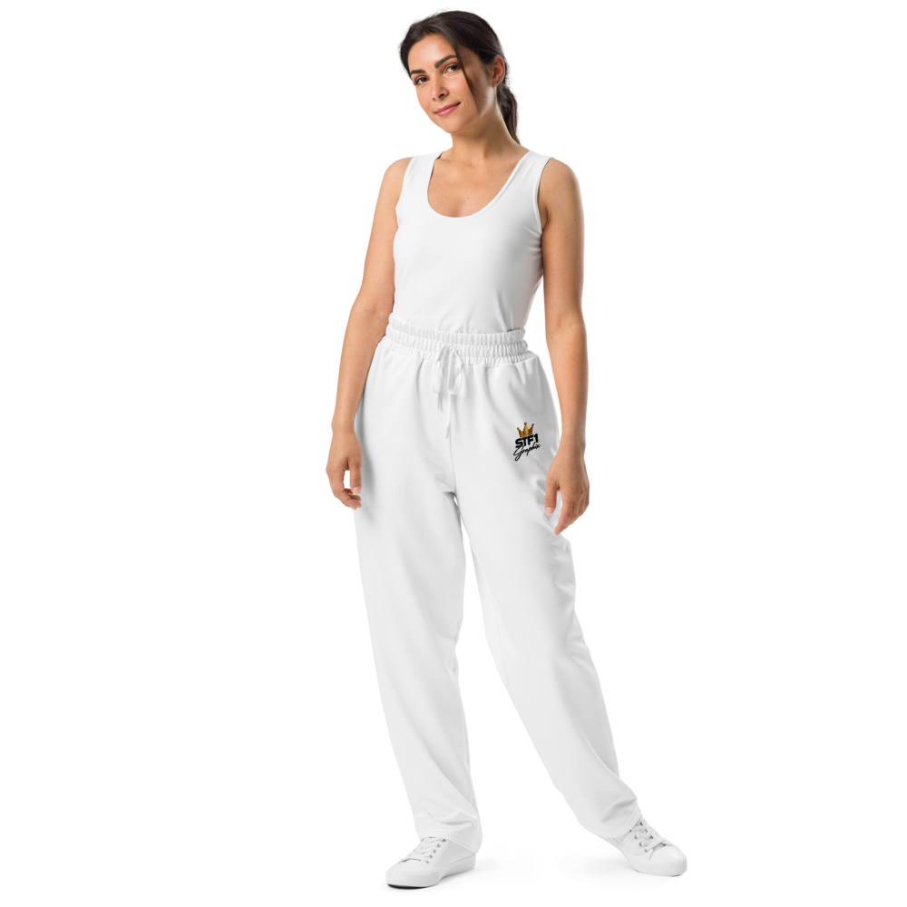 Model wearing white STF1 Graphix wide-leg joggers with a small crowned front logo.