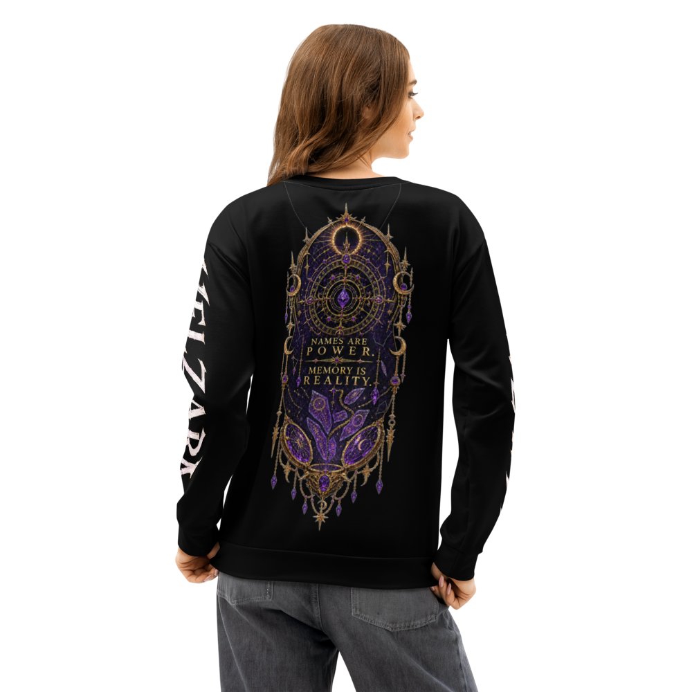 A woman shown from the back wearing a black crewneck sweatshirt with a large purple and gold mandala-style graphic on the back and white text down one sleeve, paired with gray jeans against a plain white background.
