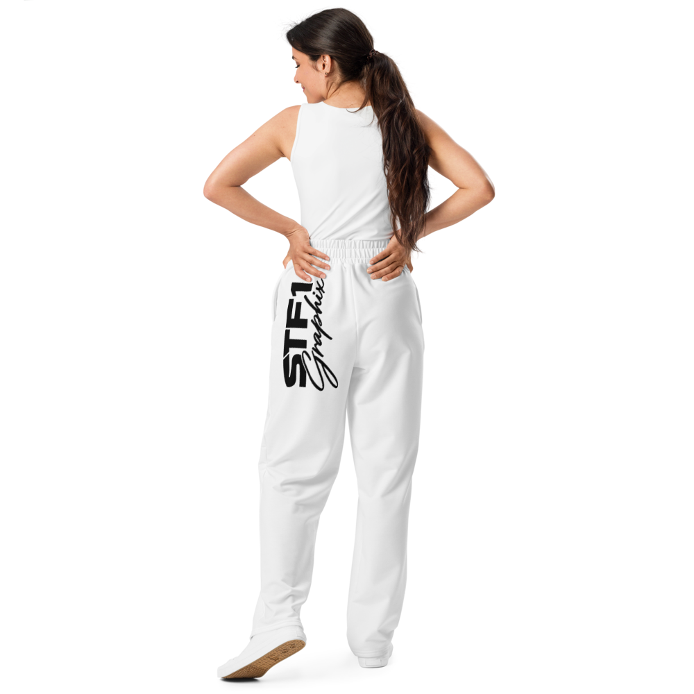 Model showing the rear fit and large black logo on white STF1 Graphix wide-leg joggers.