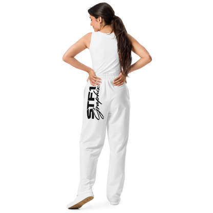 Model showing the rear fit and large black logo on white STF1 Graphix wide-leg joggers.