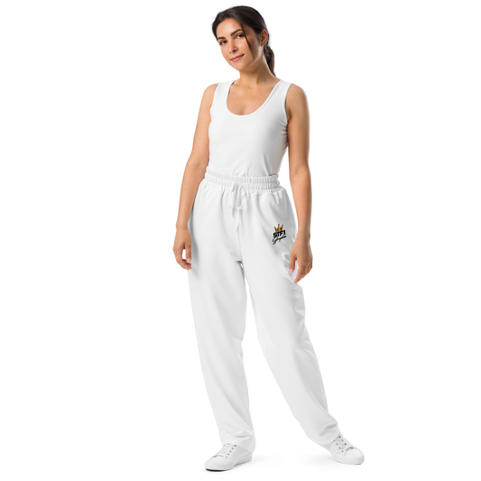 Model wearing white STF1 Graphix wide-leg joggers with a small crowned front logo.