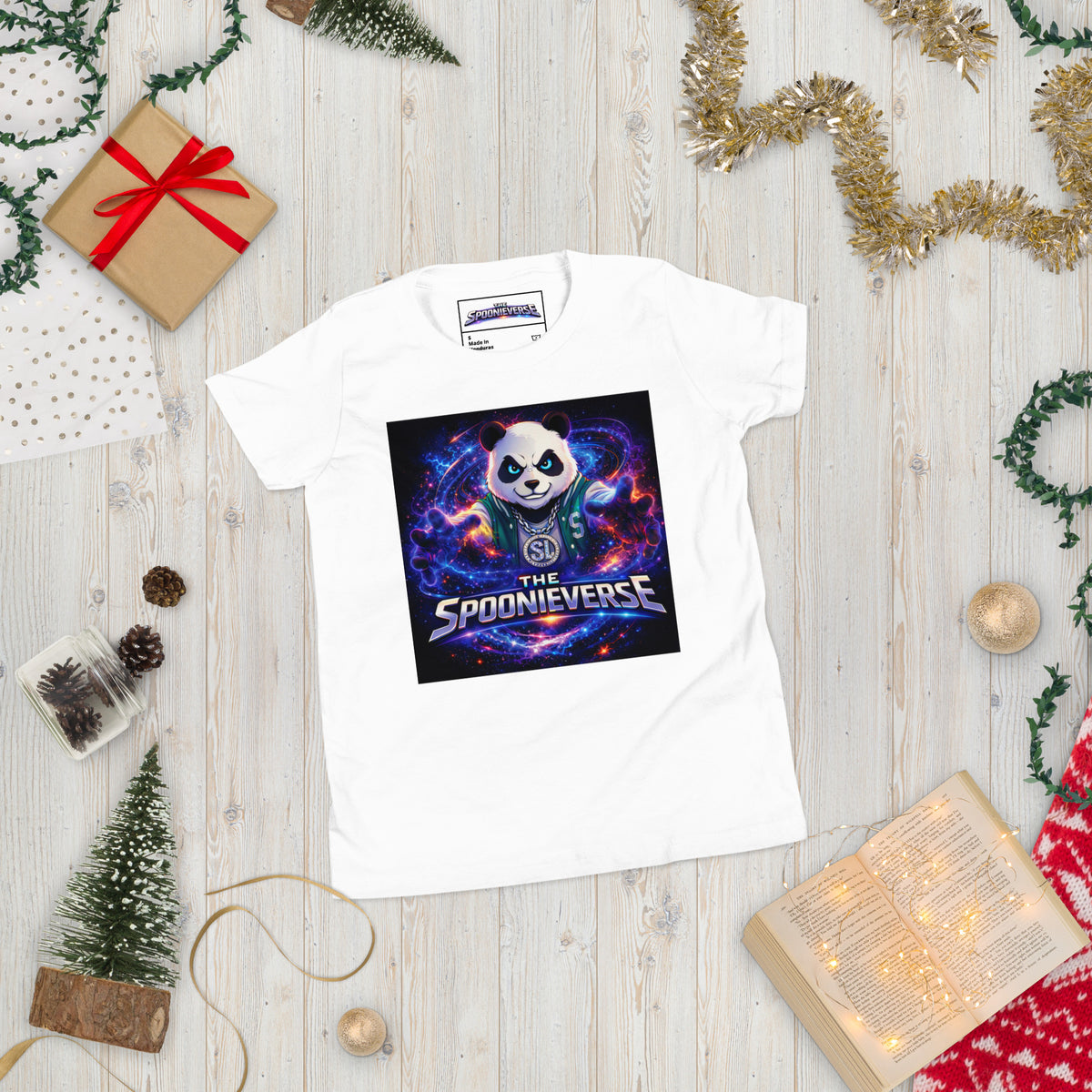 Front view of Spoonieverse logo youth graphic T-shirt White Christmas decor